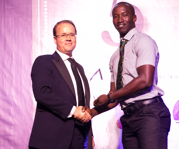 Rayvon Griffith accepts the First Class Team of the Year on behalf of Guyana