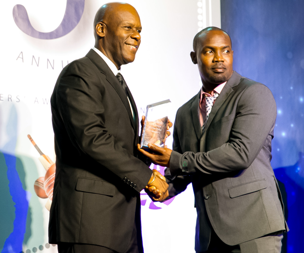Travis Dowlin accepts the Under 19 Team of the Year Award on behalf of Guyana