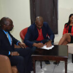 WIPA Vice President Nixon McLean signing the MoU while Director of SVGCC Nigel Scott and WIPA Member Merissa Aguilleria looks on