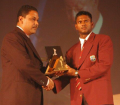 Shivnarine Chanderpaul collects the Team of the Year on behalf of Guyana